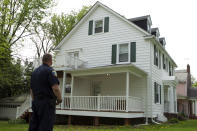 Baltimore police officer stand outside the house of Baltimore Mayor Catherine Pugh in Baltimore, MD., Thursday, April 25, 2019. Agents with the FBI and IRS are gathering evidence inside the two homes of Pugh and also in City Hall. (AP Photo/Jose Luis Magana)