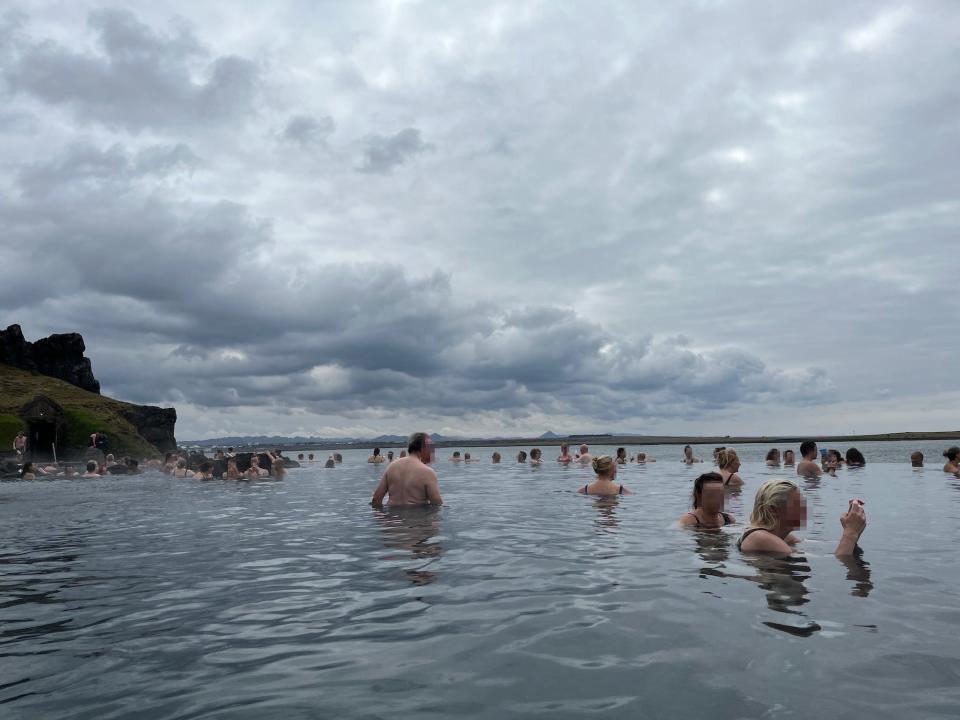 People swim at Sky Lagoon.