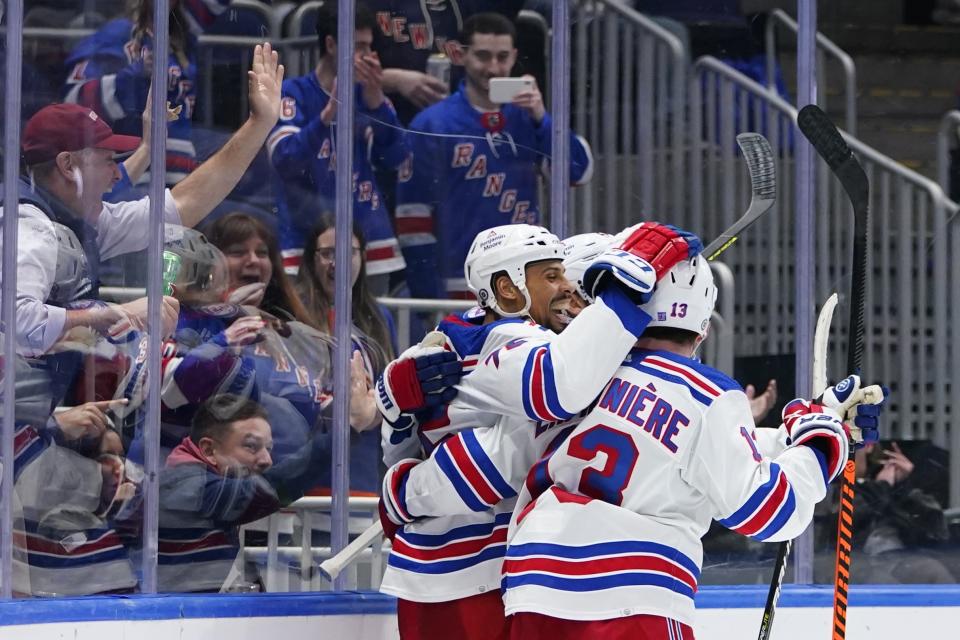 New York Rangers' Ryan Reaves (75) celebrates with teammates after scoring a goal during the third period of an NHL hockey game against the New York Islanders, Thursday, April 21, 2022, in Elmont, N.Y. (AP Photo/Frank Franklin II)