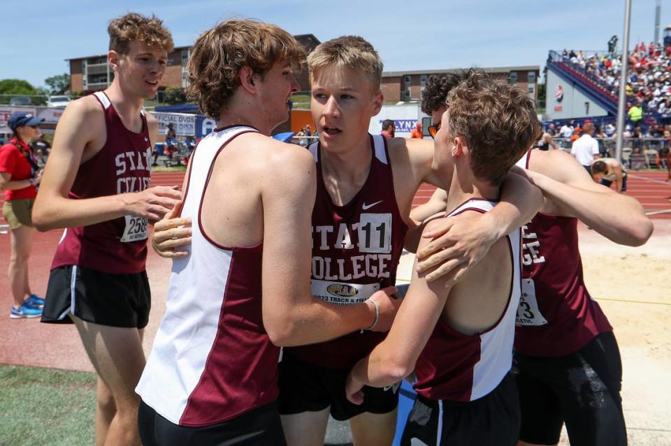 State College’s Nick Sloff, center, hugs his teammates after crossing the finish line first in their heat, but placing third overall with a time of 7:48.47 in the boys Class 3A 4x800 meter relay finals during the PIAA State Track and Field Championships held Saturday at Seth Grove Stadium on the Shippensburg University campus in Shippensburg.