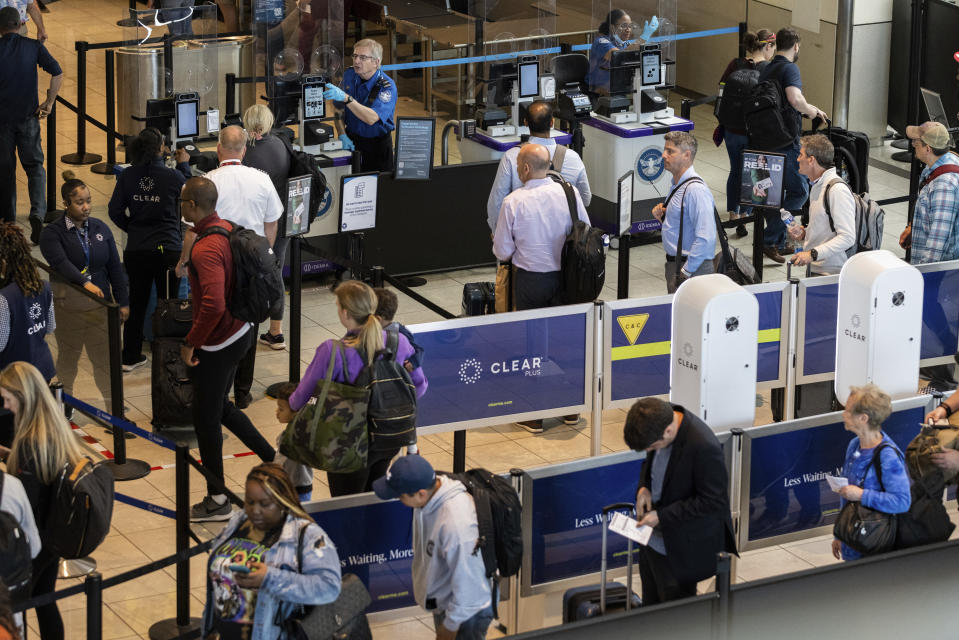 Travelers wait in line at a Baltimore-Washington International Thurgood Marshall Airport security checkpoint to use the Transportation Security Administration's new facial recognition, Wednesday, April 26, 2023, in Glen Burnie, Md. (AP Photo/Julia Nikhinson)