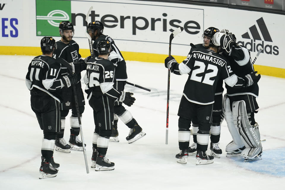 Los Angeles Kings players celebrate a 4-2 win over Colorado Avalanche in an NHL hockey game Thursday, Jan. 21, 2021, in Los Angeles. (AP Photo/Ashley Landis)