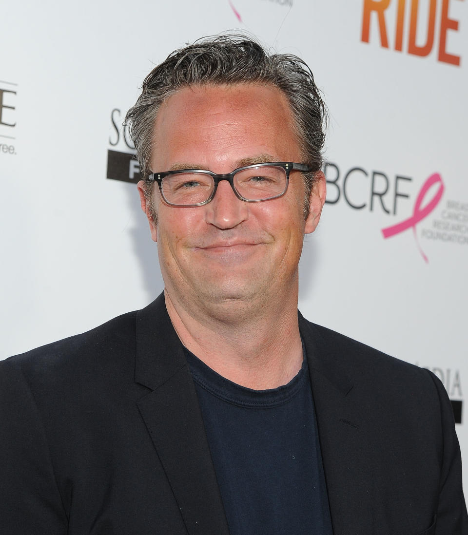 Matthew Perry smiling on the red carpet of a media event