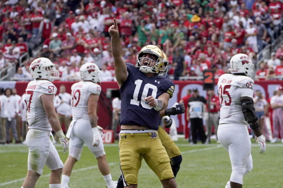 Notre Dame quarterback Drew Pyne celebrates his touchdown pass to wide receiver Kevin Austin Jr. during the second half of an NCAA college football game against Wisconsin Saturday, Sept. 25, 2021, in Chicago. Notre Dame won 41-13. (AP Photo/Charles Rex Arbogast)