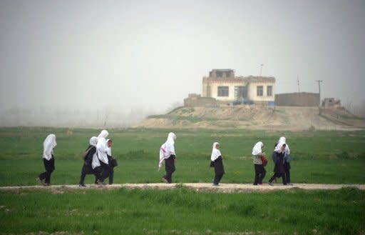 File illustration photo shows girls walking home from school in the province of Kunduz, Afghanistan. Alleged poisonings of Afghan schoolgirls by Taliban insurgents regularly make headlines -- but there are signs the incidents could be cases of mass hysteria, say specialists in the field