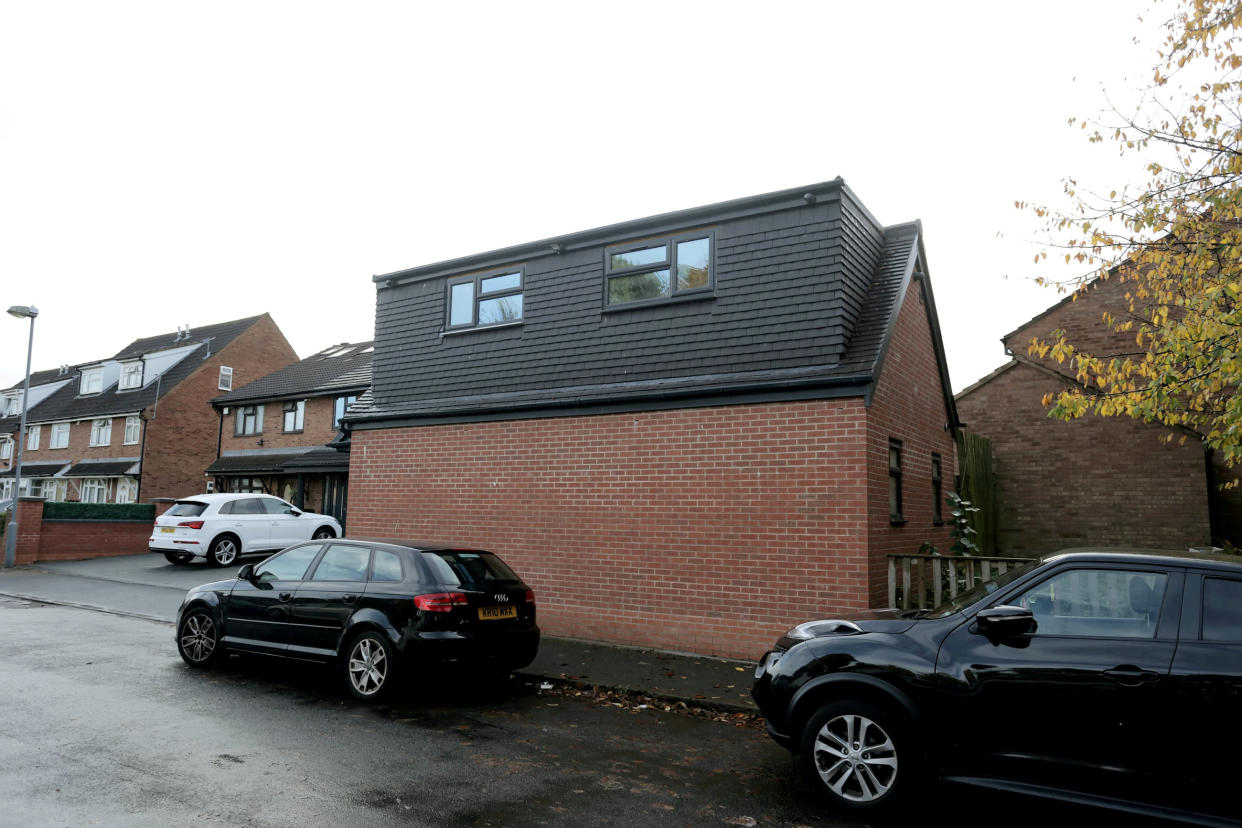 The building, which appears to be a small detached house, was built when there was only permission for a single story garage. (SWNS)