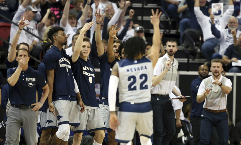 The Nevada bench reacts after Nevada's Jazz Johnson (22) sunk a 3-point shot during the second half of an NCAA college basketball game against Boise State in the Mountain West Conference men's tournament Thursday, March 14, 2019, in Las Vegas. (AP Photo/Isaac Brekken)