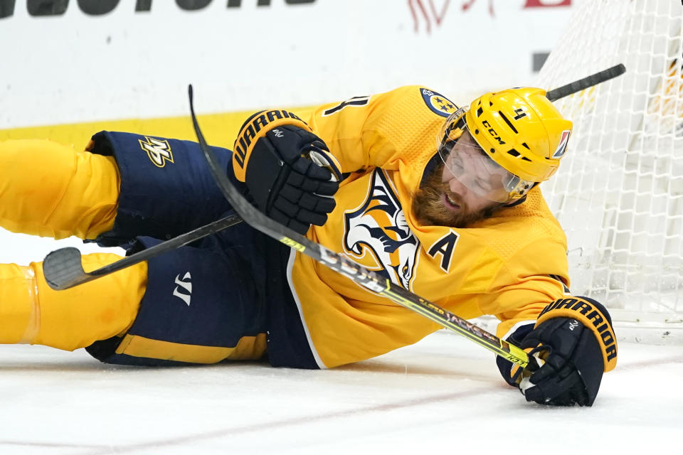 Nashville Predators defenseman Ryan Ellis (4) falls with his stick and the stick of an opponent in the third period of an NHL hockey game between the Nashville Predators and the Dallas Stars Saturday, May 1, 2021, in Nashville, Tenn. (AP Photo/Mark Humphrey)