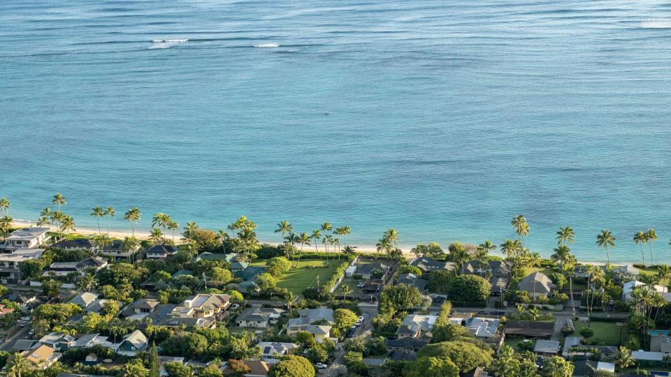 The sunrise lights up the high-end homes of the Lanikai neighborhood. This is the view from Lanikai Pillbox trail.