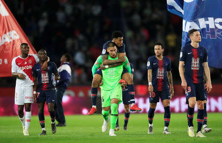 Soccer Football - Ligue 1 - Paris St Germain v AS Monaco - Parc des Princes, Paris, France - April 21, 2019 Paris St Germain's Presnel Kimpembe and Alphonse Areola celebrate after the match REUTERS/Gonzalo Fuentes