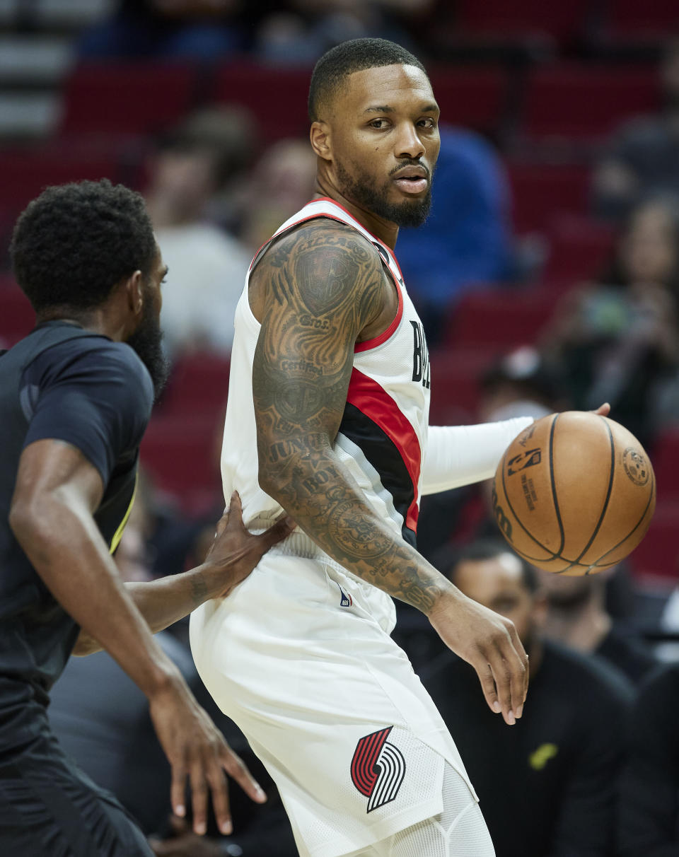 Portland Trail Blazers guard Damian Lillard posts up against the Utah Jazz during the first half of an NBA preseason basketball game in Portland, Ore., Tuesday, Oct. 4, 2022. (AP Photo/Craig Mitchelldyer)