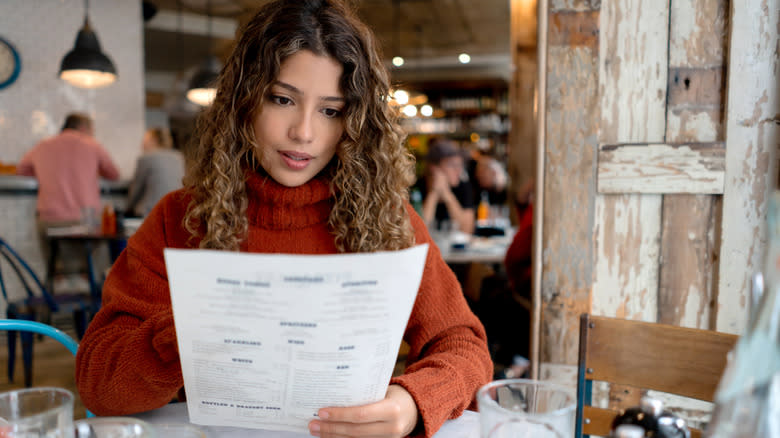 woman reviewing menu