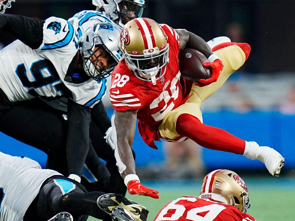 Tevin Coleman dives forward against the Carolina Panthers.