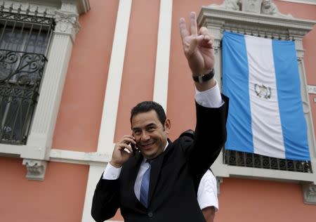 Guatemalan presidential candidate Jimmy Morales of the National Convergence Front, gestures as he speaks on a mobile phone outside the Supreme Electoral Tribunal (TSE) in Guatemala City, October 21, 2015. Morales and Sandra Torres, presidential candidate of the National Unity of Hope (UNE) political party, pledged on Wednesday not to attack each other in the remaining time until the presidential elections on October 25. REUTERS/Jorge Dan Lopez