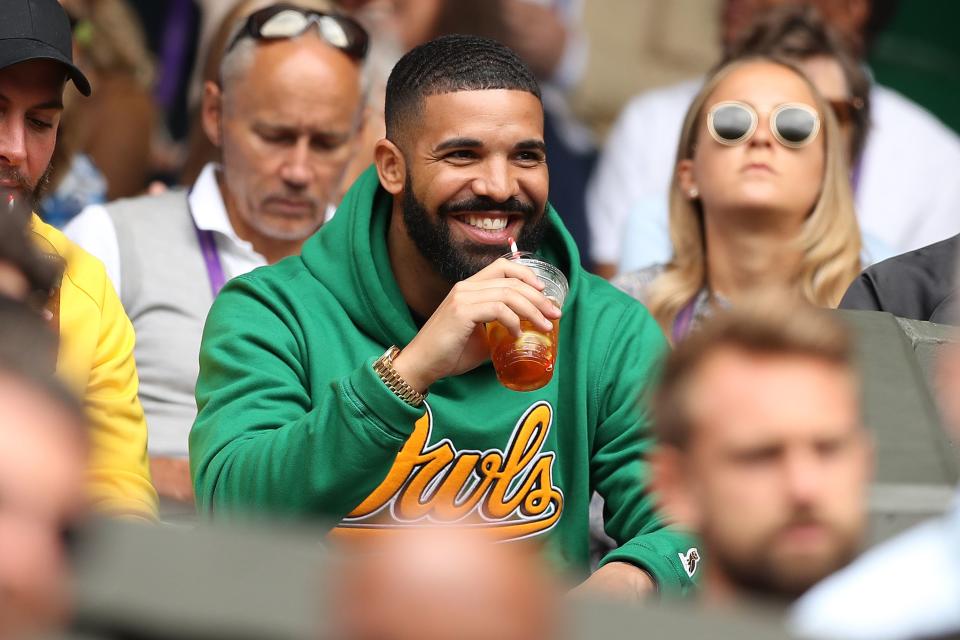 Drake watched Serena Williams at Wimbledon in 2018, one of his many appearances at different sporting events in different team gear. (Daniel Leal-Olivas/AFP/Getty Images)