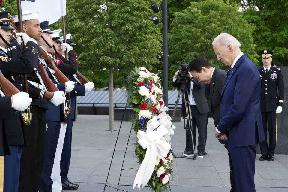 President Joe Biden and South Korea's President Yoon Suk Yeol pause as they lay a wreath during a visit the Korean War Veterans Memorial in Washington, Tuesday, April 25, 2023. (AP Photo/Susan Walsh)