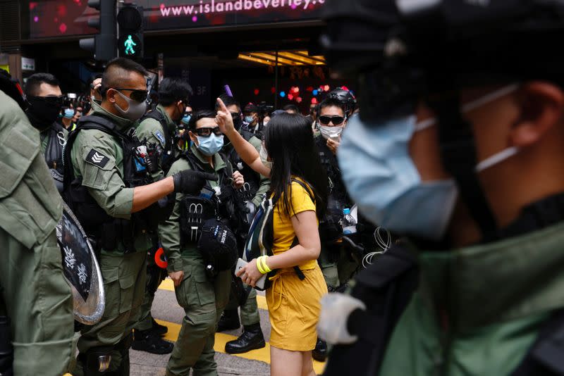 Pro-democracy protester argues with police before a protest in Hong Kong