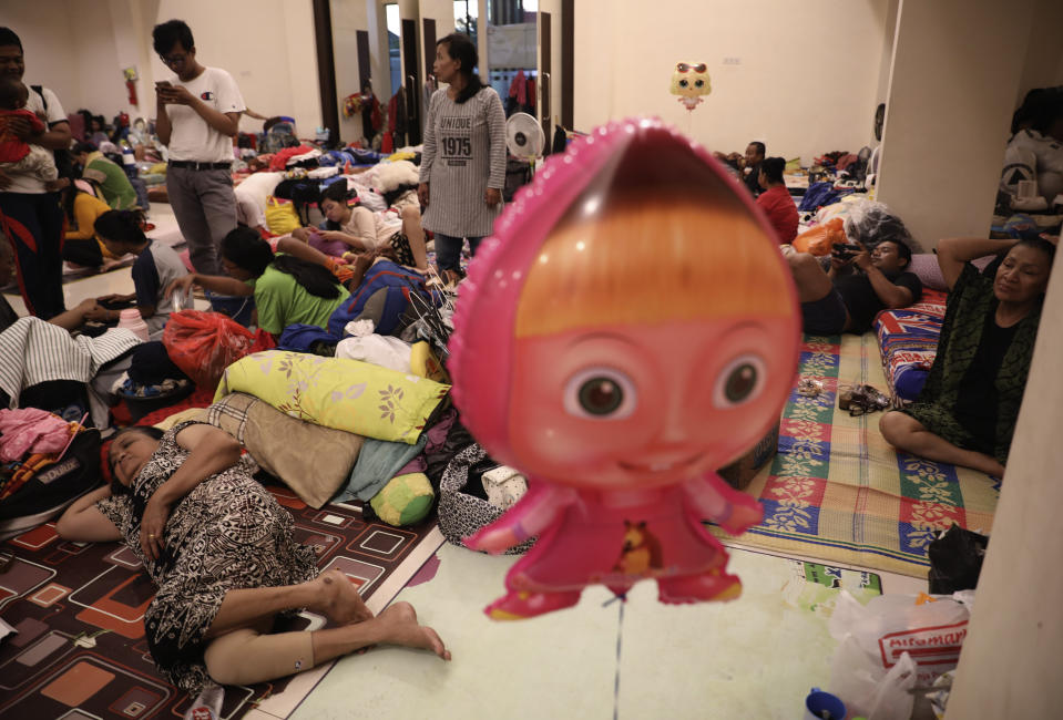 People affected by flood rest at a temporary shelter in Jakarta, Indonesia, Friday, Jan. 3, 2020. Severe flooding in the capital as residents celebrated the new year has killed dozens of people and displaced hundreds of thousands others. (AP Photo/Dita Alangkara)
