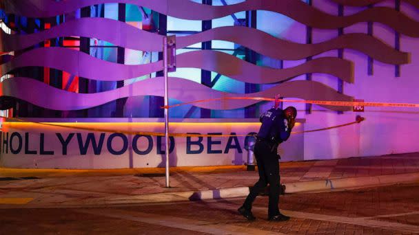 PHOTO: An officer passes through a crime scene tape cordon along a street as they respond to a shooting at Hollywood Beach, May 29, 2023 in Hollywood, Florida. (Eva Marie Uzcategui/Getty Images)
