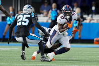 Denver Broncos running back Marlon Mack is tackled by Carolina Panthers linebacker Frankie Luvu during the second half of an NFL football game between the Carolina Panthers and the Denver Broncos on Sunday, Nov. 27, 2022, in Charlotte, N.C. (AP Photo/Rusty Jones)