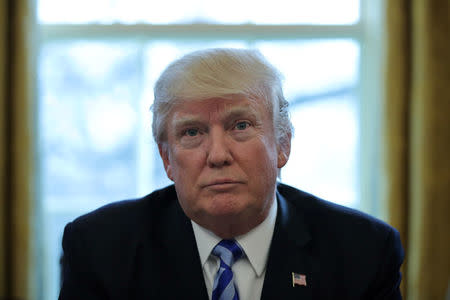 U.S. President Donald Trump talks to journalists at the Oval Office of the White House after the AHCA health care bill was pulled before a vote in Washington, U.S. March 24, 2017. REUTERS/Carlos Barria