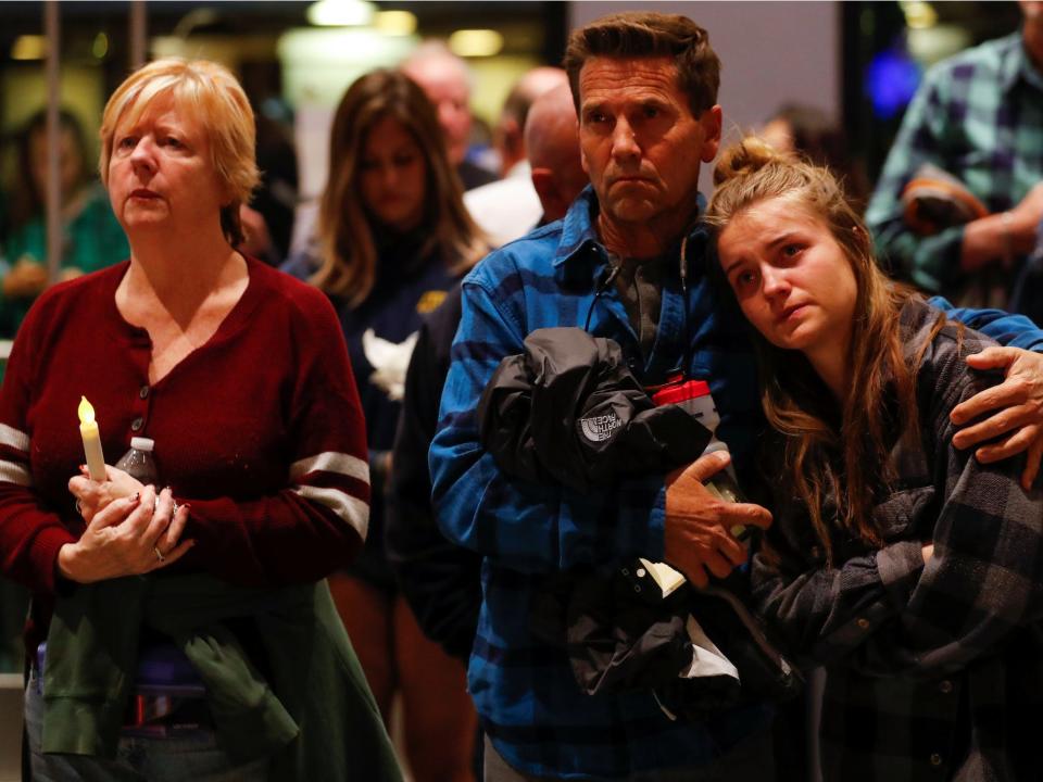 Mourners attend a vigil for the victims of the mass shooting.