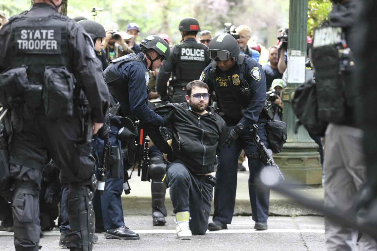 A protester is detained by Portland police during a demonstration in Portland: AP