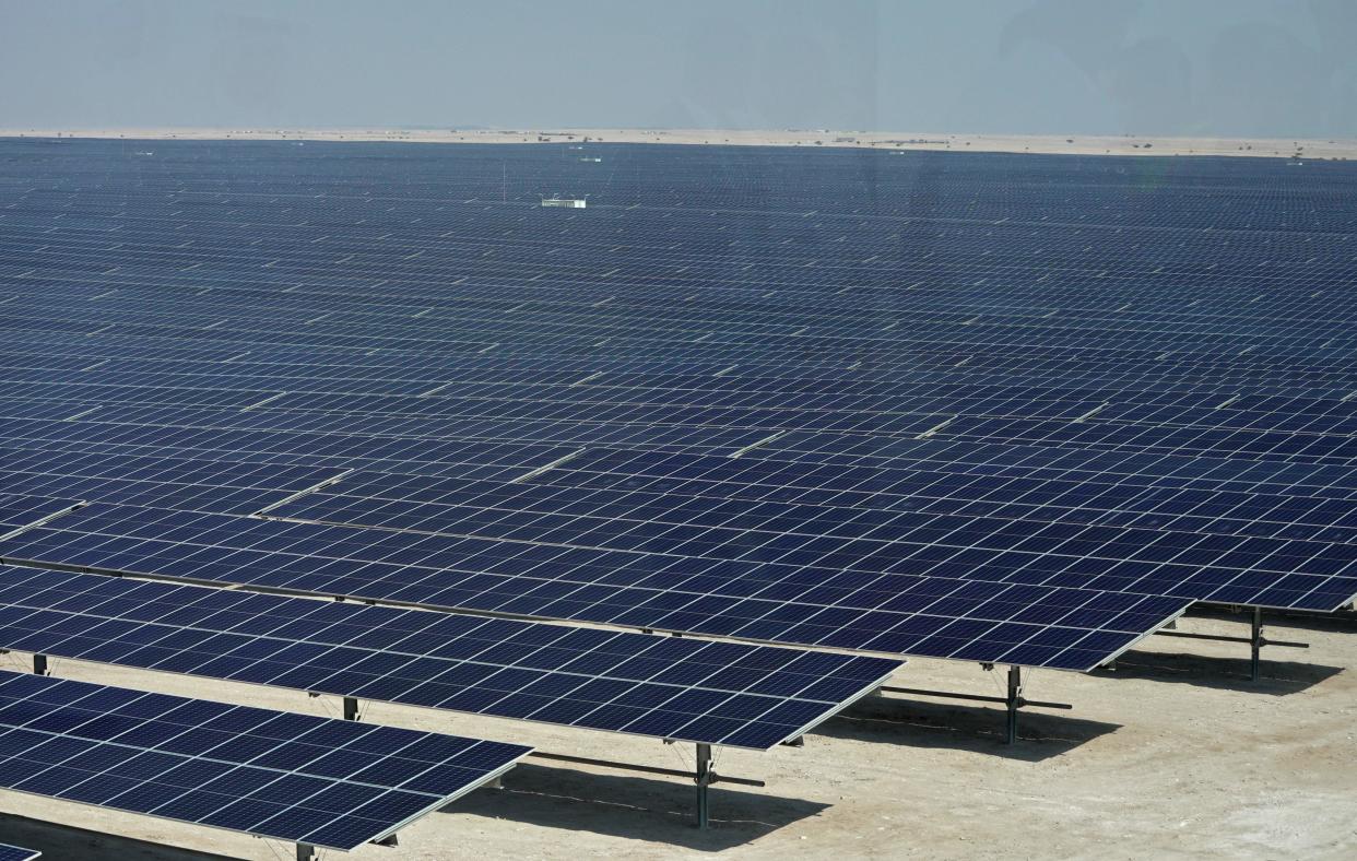 This picture taken on October 18, 2022 shows a view of solar panels at the newly-inaugurated al-Kharsaah solar power plant in Qatar. - Gas-rich Qatar inaugurated its first solar plant on October 18, which organisers of the World Cup have said will provide clean energy for its stadiums. The solar farm in al-Kharsaah, west of the capital, is 