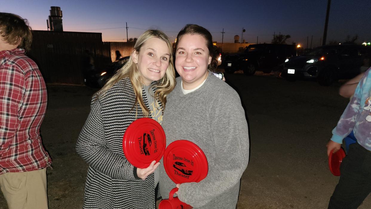 Loyal patrons hold their custom frisbees from the Tascosa Drive-in Friday night its final showing in Amarillo.