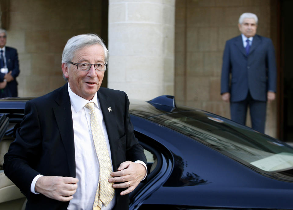 Eurogroup head Jean-Claude Juncker, foreground, arrives at Cyprus’ Presidential Palace for a meeting with Cypriot President Dimitris Christofias on the sidelines to an informal meeting of European finance ministers in the Cypriot capital, Friday, Sept. 14, 2012. Spain appeared Friday to be inching closer to making a formal request for financial help, while Greece’s euro partners gave a big hint that the heavily-indebted country may get more time, but not money, to get its public finances into shape. (AP Photo/Philippos Christou)