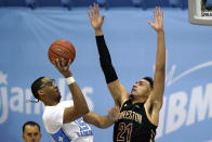 North Carolina forward Garrison Brooks (15) shoots while College of Charleston forward Lorenzo Edwards (21) defends during the second half of an NCAA college basketball game in Chapel Hill, N.C., Wednesday, Nov. 25, 2020. (AP Photo/Gerry Broome)