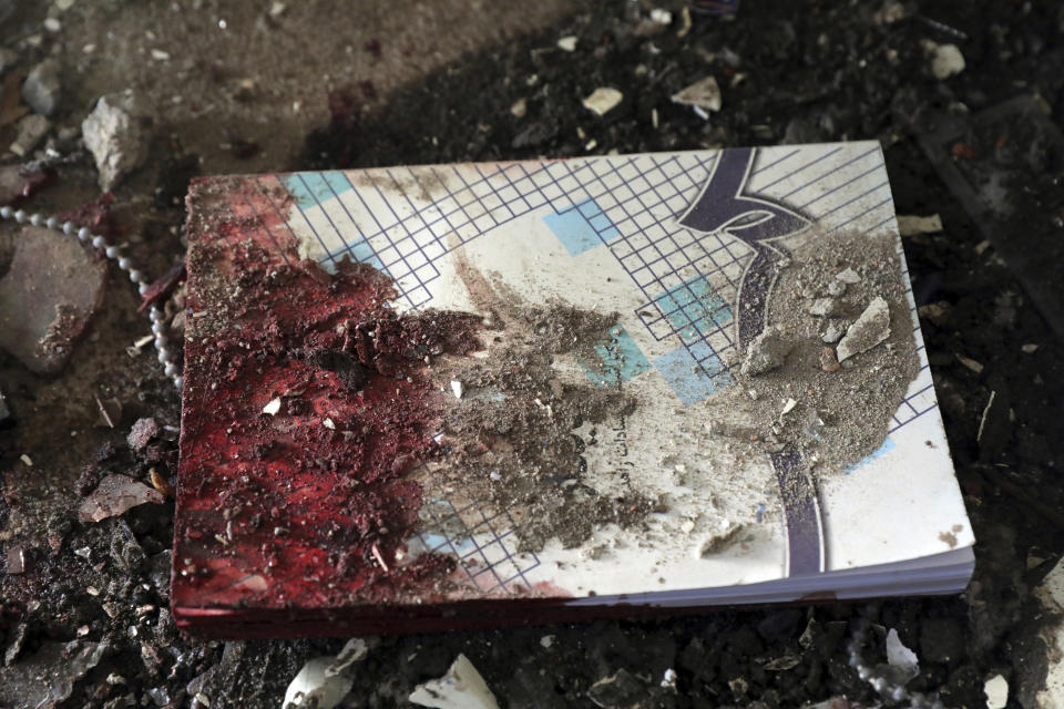 A blood-stained book is seen on the ground inside the Kabul University after a deadly attack in Kabul, Afghanistan, Tuesday, Nov. 3, 2020. The brazen attack by gunmen who stormed the university has left many dead and wounded in the Afghan capital. The assault sparked an hours-long gun battle. (AP Photo/Rahmat Gul)
