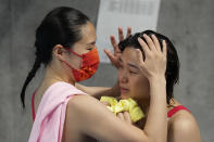 Shi Tingmao of China, right, gold medal and Wang Han of China, silver medal react after women's diving 3m springboard final at the Tokyo Aquatics Centre at the 2020 Summer Olympics, Sunday, Aug. 1, 2021, in Tokyo, Japan. (AP Photo/Dmitri Lovetsky)