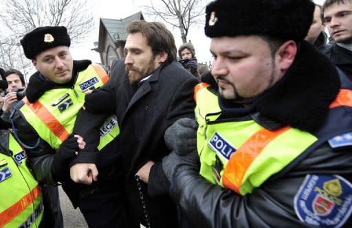 A member of the green-leftist LMP party Gabor Vago (centre) is arrested by police outside the Hungarian Parliament in December 2011 during a demonstration against Prime Minister Viktor Orban's government. The European Union executive has launched legal action against Hungary over contested reforms of its judiciary, central bank and data protection authority