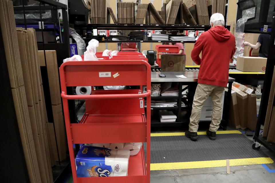 FILE- In this Nov. 16, 2018, photo an assembly line worker packages items from an online order to be shipped out of a Target store in Edison, N.J. Target is offering same-day delivery on thousands of items for $9.99 per order through a delivery startup it purchased nearly two years ago. (AP Photo/Julio Cortez, File)