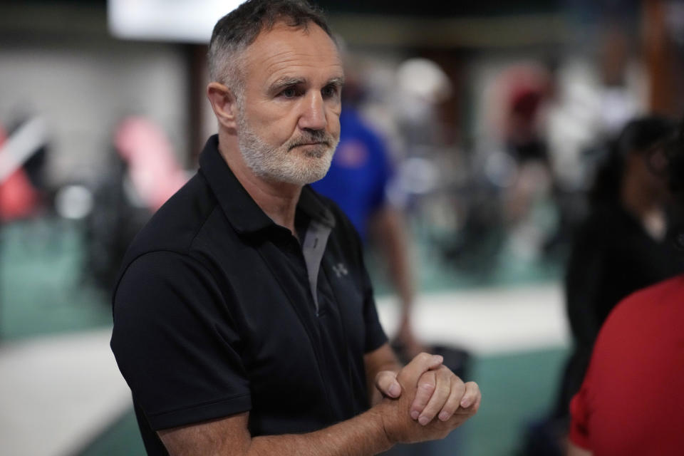 FILE - In this Monday, June 7, 2021, file photo, USA Boxing head coach Billy Walsh takes part in drills during a media day for the team in a gym located in a converted Macy's Department store in Colorado Springs, Colo. After a half-decade of turmoil and drama at the highest levels of Olympic boxing, the sport's trip to Tokyo looks as if it could be fairly smooth. At least as smooth as this notoriously chaotic sport ever gets. “I hope it'll be a situation where we get to see the best boxers rewarded for the best performances,” Walsh said. (AP Photo/David Zalubowski, File)