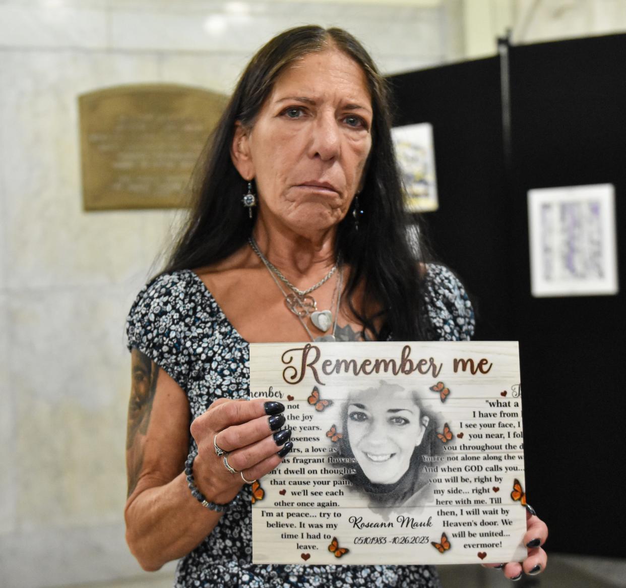 Barb Mauk, Roseann Mauk's mother, attends Brandt Saunders' sentencing with a sign bearing a picture of her daughter Monday in Akron.
