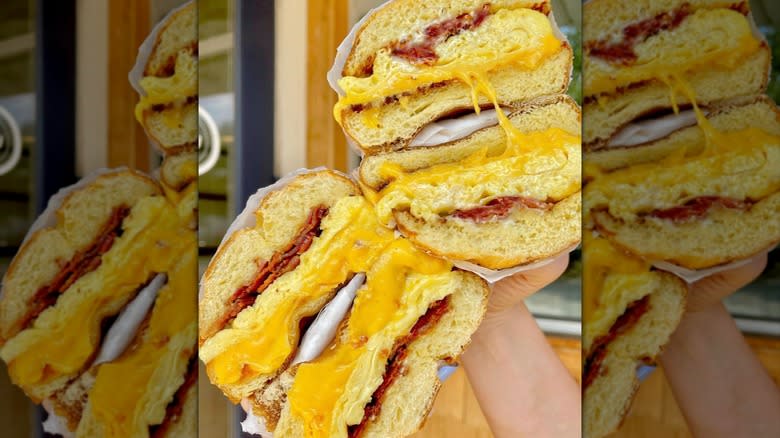 two sliced and stacked bacon egg and cheese sandwiches with melted cheese