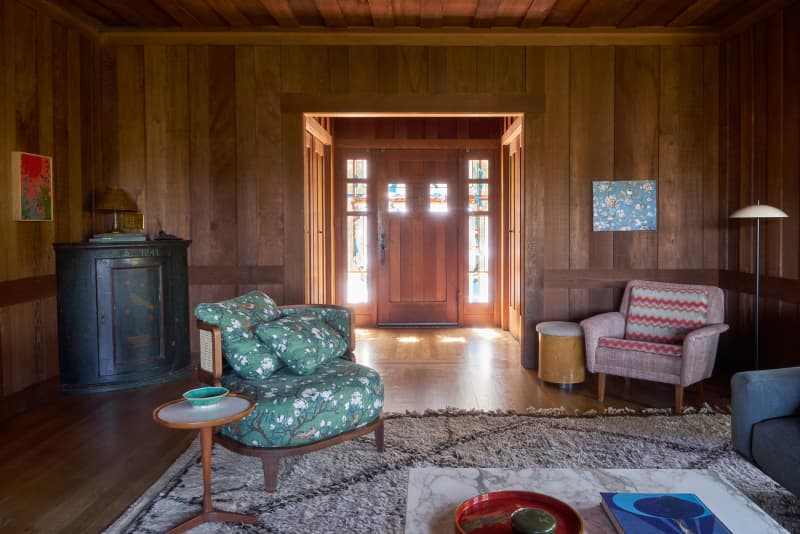 Wood paneled walls and door in newly renovated living room.