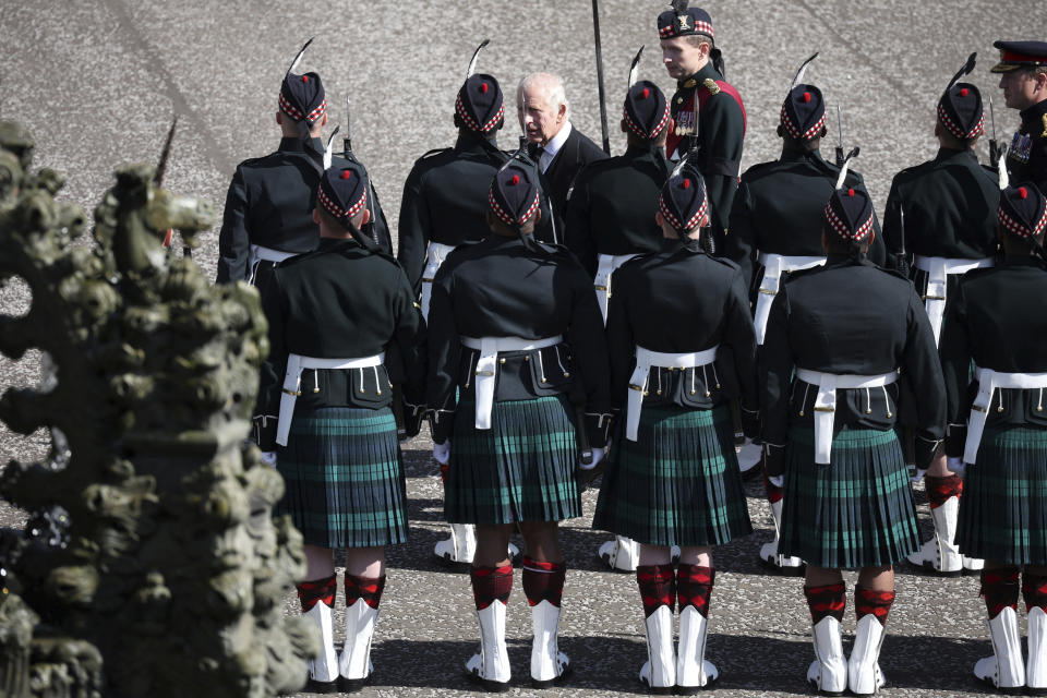 Britain's King Charles inspects an honour guard at the Palace of Holyroodhouse, following the death of Britain's Queen Elizabeth, Edinburgh, Scotland, Monday Sept. 12, 2022. King Charles III will accompany the queen coffin on a solemn procession through the cobbled streets of the Scottish capital from the royal Palace of Holyroodhouse to St. Giles' Cathedral, where members of the public will be able to pay their respects. (Phil Noble/pool photo via AP)