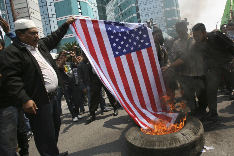 Indonesian Muslims burn an American flag during a protest against an American-made film that ridicules Prophet Muhammad outside the U.S. Consulate in Medan, North Sumatra, Indonesia, Tuesday, Sept. 18, 2012. Indonesians continue to protest the anti-Islam film "Innocence of Muslims," torching the flag and tires outside the consulate in the country's third largest city of Medan. (AP Photo/Binsar Bakkara)