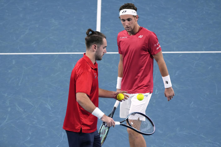 Norway's Casper Ruud, right, and Viktor Durasovic discuss tactics during their doubles match against Serbia's Nikola Cacic and Filip Krajinovic at the ATP Cup tennis tournament in Sydney, Saturday, Jan. 1, 2022. (AP Photo/Rick Rycroft)