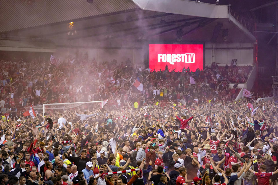 Nottingham Forest fans celebrate on the pitch after they reach the play off final during the Sky Bet Championship play-off semi-final, second leg match at the City Ground, Nottingham. Picture date: Tuesday May 17, 2022.