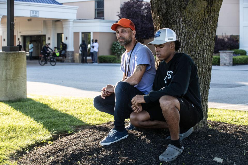 Jorge, 43, and Renny, 22, both from Venezuela, are two of the dozens of asylum seekers that were brought from New York City to the Crossroads Hotel in Newburgh. Both men, photographed outside the hotel May 31, 2023, said that they had to flee their home country because of danger faced by themselves and their families had they stayed. Jorge left a wife and two daughters behind. 