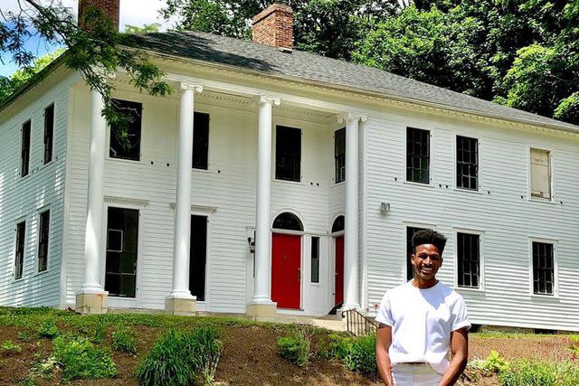 <p>Robert Hartwell/Instagram</p> Robert Hartwell standing in front of his Massachusetts home