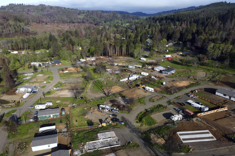 The town of Otis, Ore., is seen in this aerial photo on Thursday, May. 13, 2020. The small Oregon coast town is still recovering from the devastating fire that destroyed 293 homes. Experts say the 2020 wildfire season in Oregon was a taste of what lies ahead as climate change makes blazes more likely and more destructive even in wetter, cooler climates like the Pacific Northwest. (AP Photo/Craig Mitchelldyer)