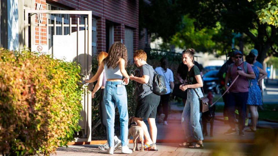 Residents and their pets return to the C.W. Moore Apartments in downtown Boise after a car fire in the first floor parking garage was extinguished by the Boise Fire Department on Thursday, Oct. 6, 2022.