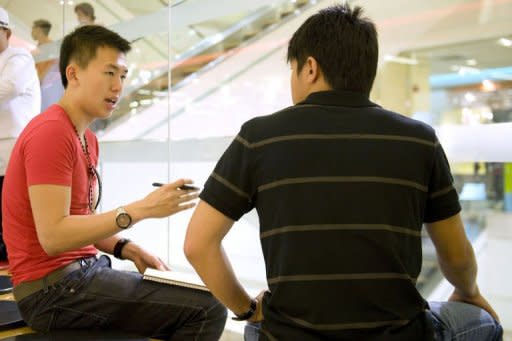 Dating coach Xavier See (left) teaches a student how to speak to women in the hope of finding a girlfriend in Singapore. With 43 percent of Singaporean men between 30 and 34 -- the prime marrying age -- unattached, See has plenty of potential clients in the wealthy city