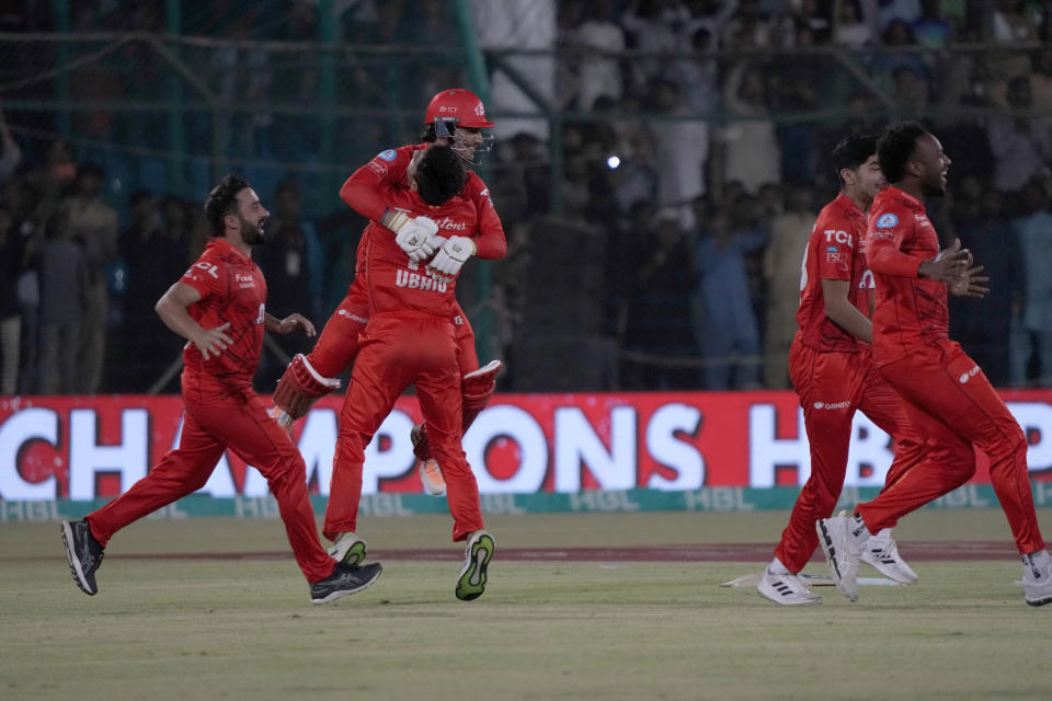 Islamabad United' Hunain Shah, center face to camera, celebrates with teammates after playing winning shot during the final of Pakistan Super League T20 cricket match between Islamabad United and Multan Sultans, in Karachi, Pakistan, Monday March 18, 2024. (AP Photo/Fareed Khan)