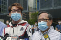 Various defendants including pro-democracy activists Figo Chan Ho-wun, left, and Albert Ho speak to media outside a court in Hong Kong, Monday, May 17, 2021. Trial starts for Jimmy Lai and nine others, accused of "incitement to knowingly take part in an unauthorized assembly" for a protest march on Oct. 1, 2019. The court has estimated 10 days for this trial. (AP Photo/Kin Cheung)